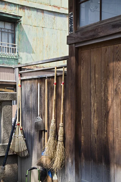 Straw Brooms on Fence — Stock Photo, Image