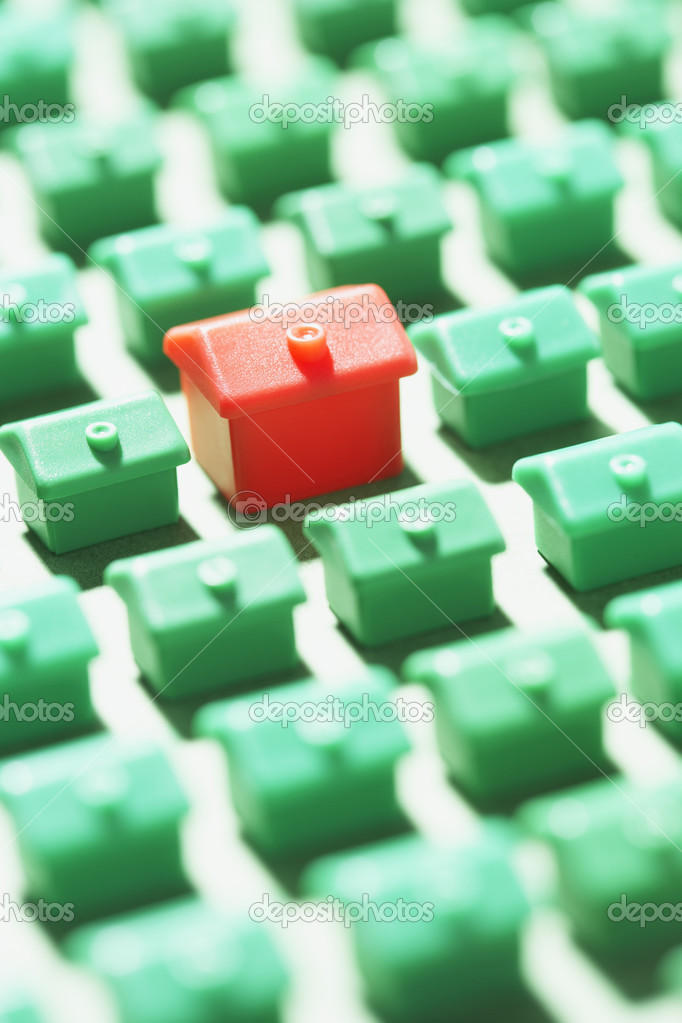 Green model houses with one red