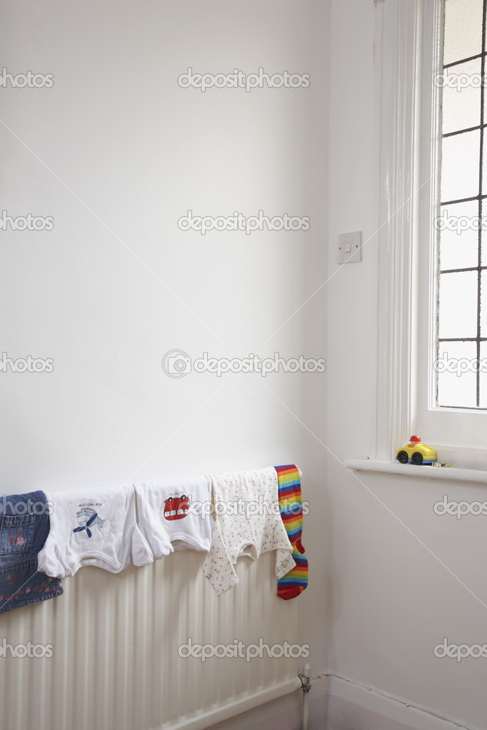 Child's clothing drying on radiator — Stock Photo © londondeposit 33893849