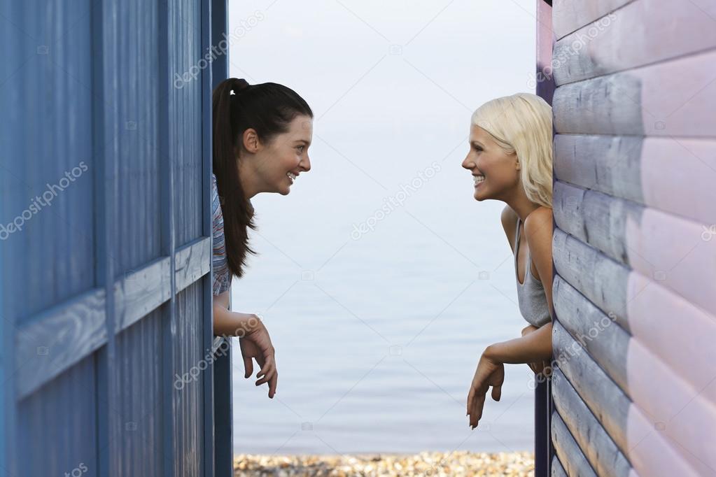 Women leaning on beach