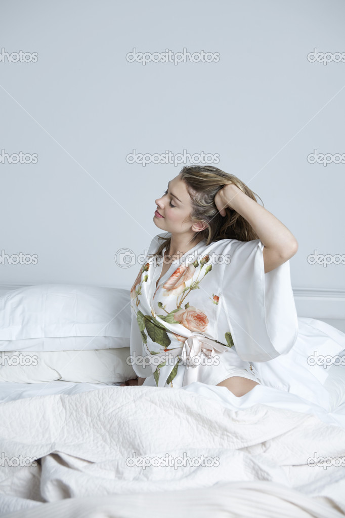 woman stretching in bed