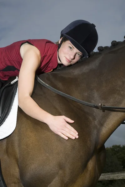 Horseback rider hugging horse — Stock Photo, Image