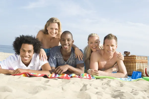 People lying on sand — Stock Photo, Image