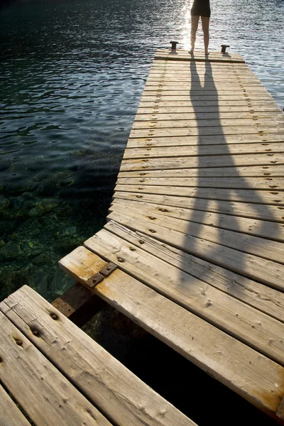 Human silhouette on jetty — Stock Photo, Image