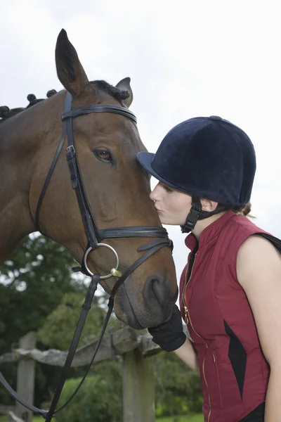 Horseback rider kissing horse — Stock Photo, Image