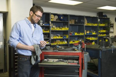 Atölyede aletleri olan bir adam