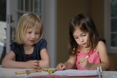 Girls drawing with crayons clipart