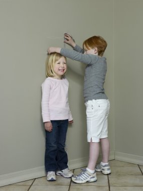sisters measuring height clipart