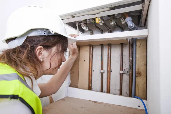 Plumber servicing central heating boiler — Stock Photo, Image