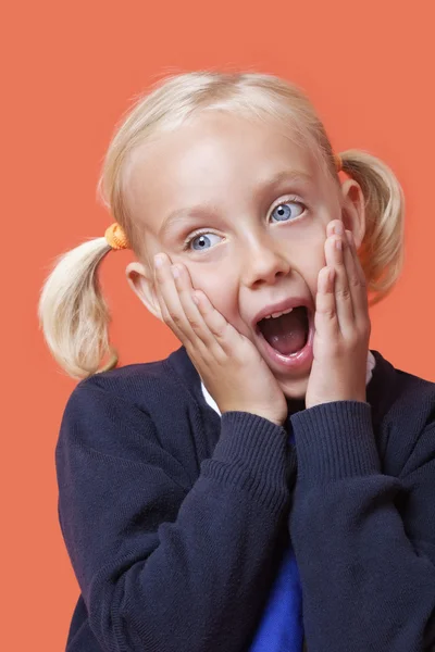 Schoolgirl with hands on face — Stock Photo, Image