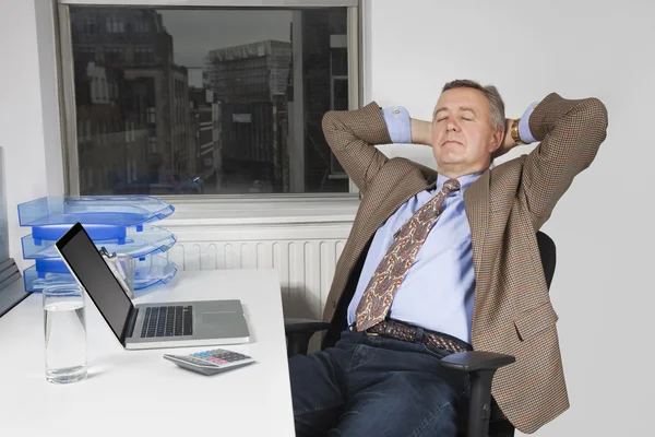 Businessman resting on chair — Stock Photo, Image