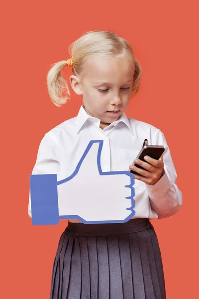 Schoolgirl holding fake like button — Stock Photo, Image