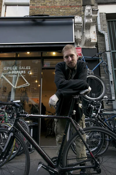 Homme debout devant magasin de vélo — Photo