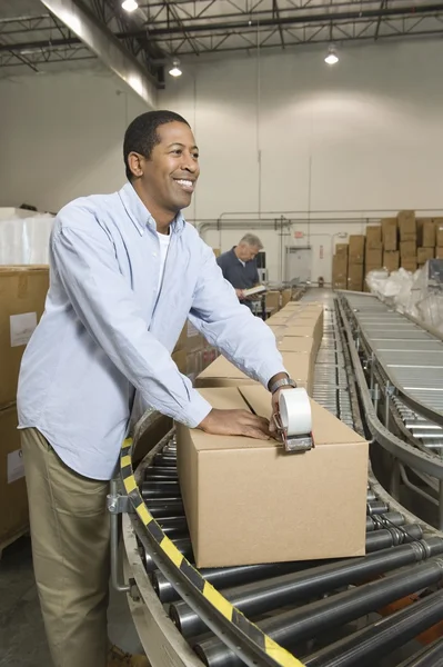 Man working in distribution warehouse — Stock Photo, Image