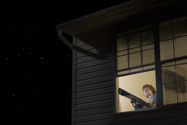 Teenage boy with telescope — Stock Photo, Image