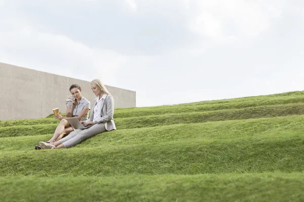 Kierownictwo firmy, siedząc na trawie — Zdjęcie stockowe