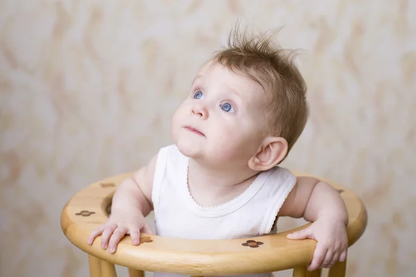 Baby boy sitting on high chair — Stock Photo, Image