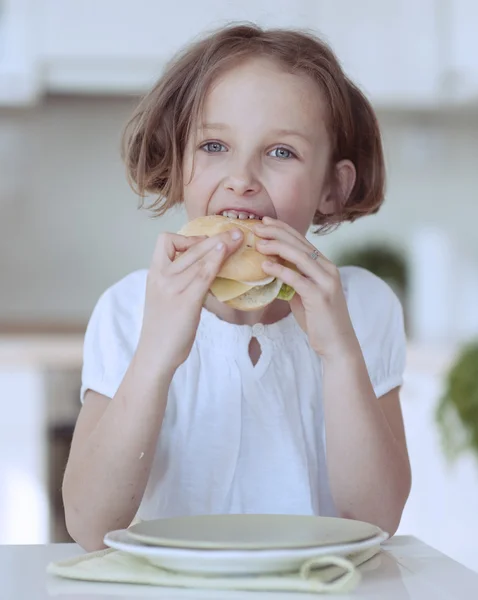 Girl eating cheese sandwich — Stock Photo, Image