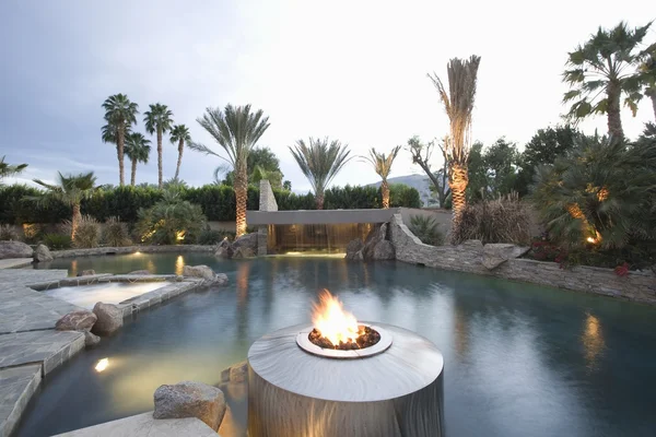 Swimming pool with live flame heater — Stock Photo, Image