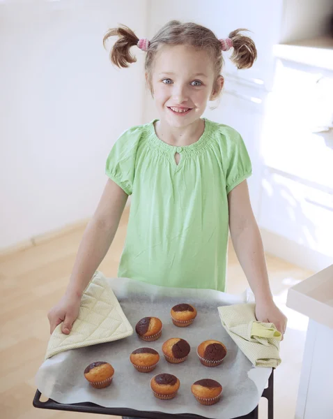 Girl holding baking tray — Stock Photo, Image