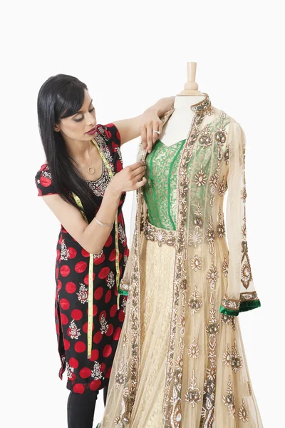 Dressmaker working on a traditional outfit — Stock Photo, Image