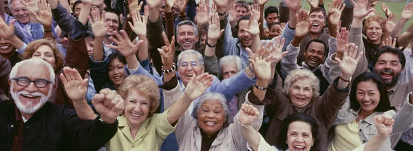 Brazos multiétnicos levantados — Foto de Stock