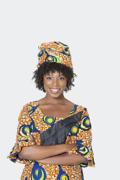 Mujer en traje de impresión africana de pie brazos cruzados — Foto de Stock