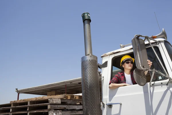 Female industrial worker adjusting mirror — Stock Photo, Image