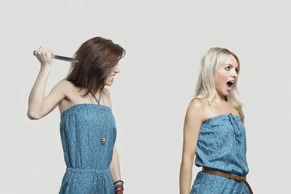 Friend stabbing young woman — Stock Photo, Image