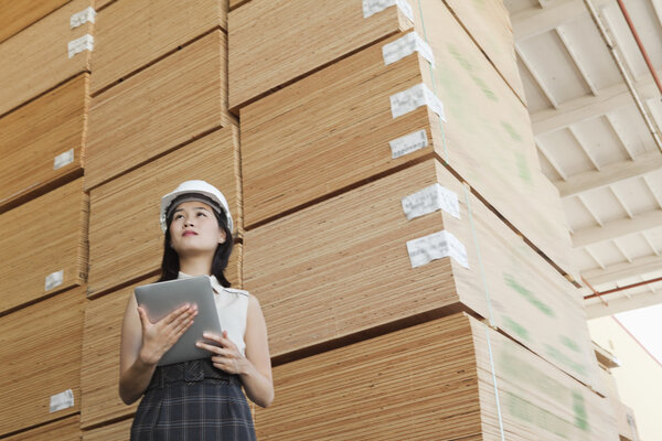 Female industrial worker holding tablet