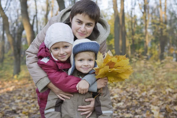 Mother embracing children — Stock Photo, Image