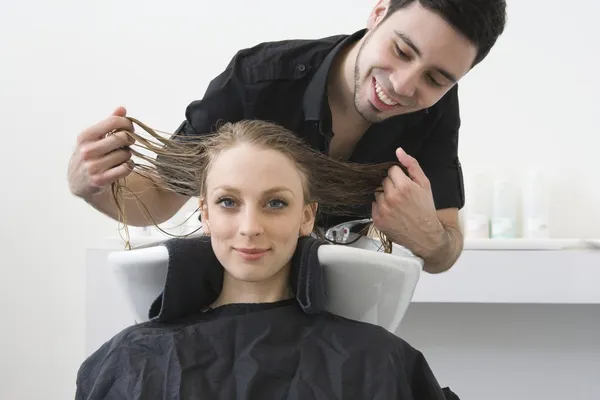 Man washing customers hair — Stock Photo, Image