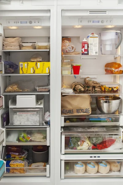 Open refrigerator with food items — Stock Photo, Image