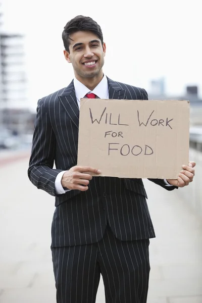 Businessman holding "Will Work for Food" sign — Stock Photo, Image