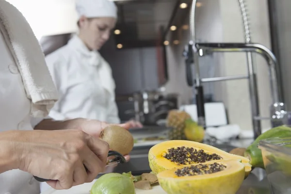 Chef peeling tropical fruit — Stock Photo, Image