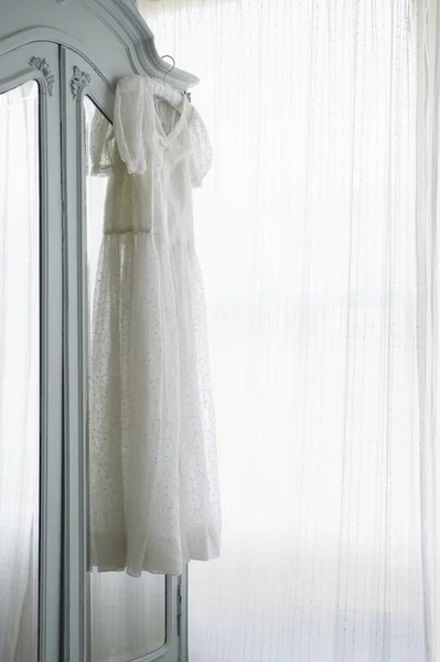 Christening gown on wardrobe — Stock Photo, Image