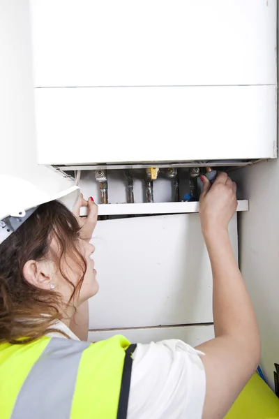 Plumber servicing central heating boiler — Stock Photo, Image