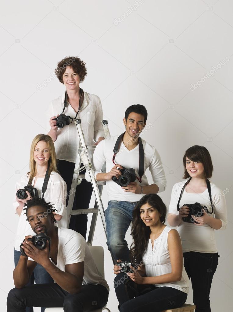 Photographers sitting on ladder and chairs