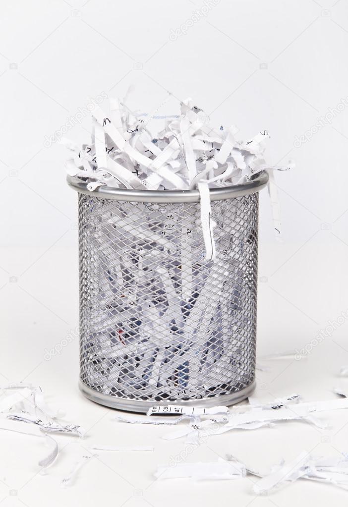 Wastepaper basket with papers
