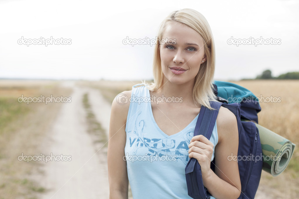 Eautiful female hiker standing on field