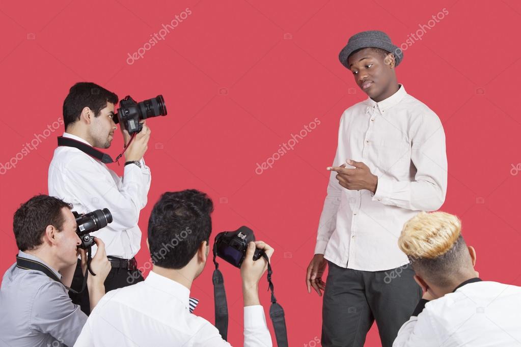 Paparazzi taking photographs of actor