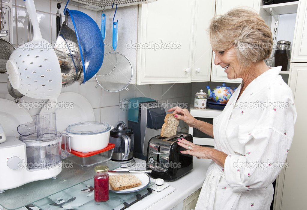 Senior woman preparing toast