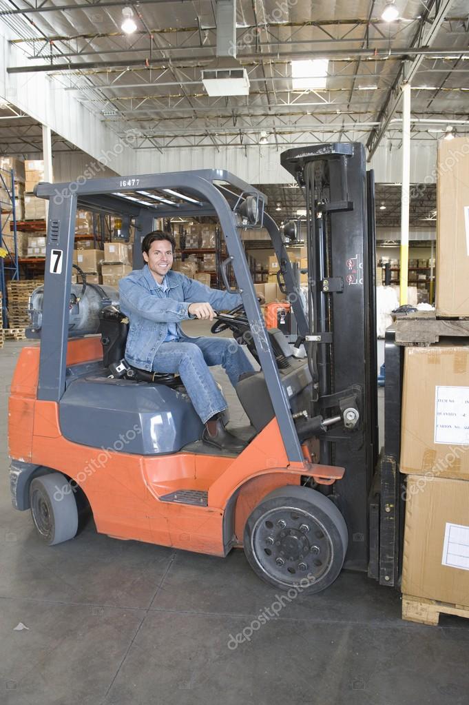 Man operating fork lift truck — Stock Photo © londondeposit 33988161