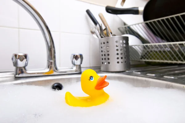 Rubber duck in kitchen sink — Stock Photo, Image