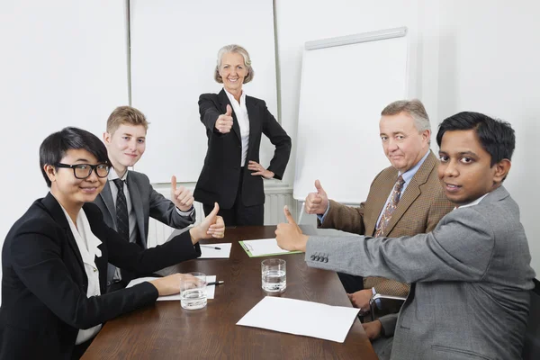 Multiethnic business people thumbs up — Stock Photo, Image