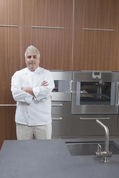 Mid- adult chef stands with arms folded — Stock Photo, Image