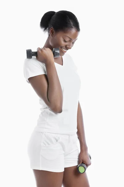 Thoughtful woman with dumbbells — Stock Photo, Image