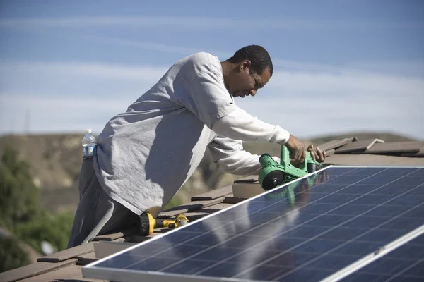 Man on a rooftop working — Stock Photo, Image