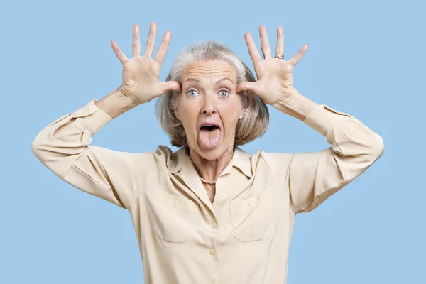 Senior woman making funny faces — Stock Photo, Image