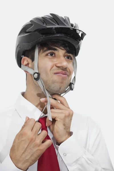 Indian businessman adjusting cycling helmet — Stock Photo, Image